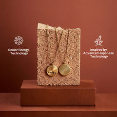 Stainless steel energy pendant with 4 power stones displayed on stand, inspired by Japanese technology